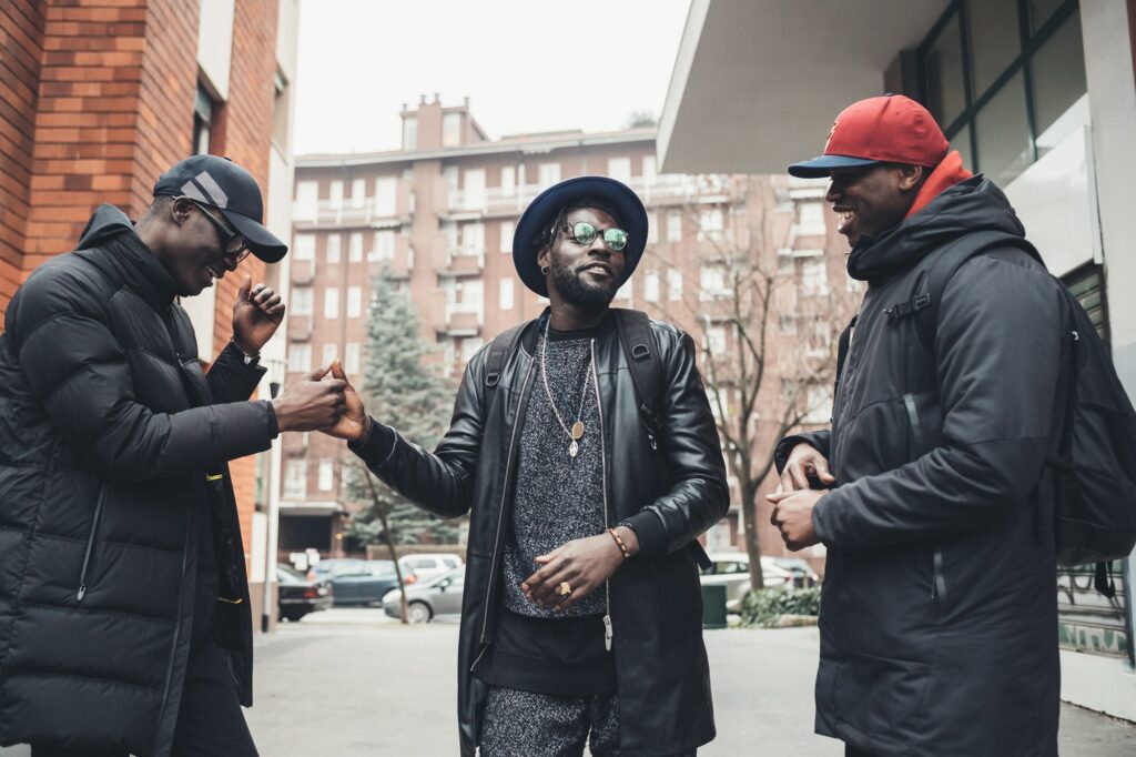 three african men greeting in the street